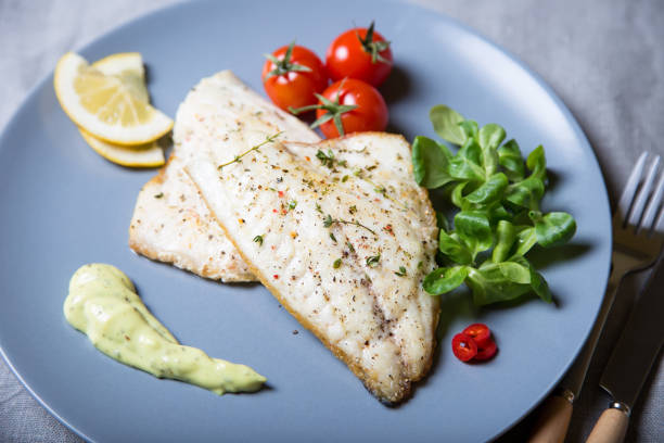 istock Fried dorado fillet with tomatoes, lemon and corn salad. 1133576579