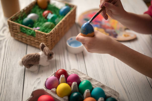 istock DIY young woman paints colorfull easter eggs 1133576665