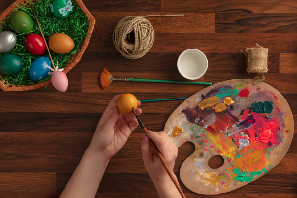 istock Top view of colorful easter eggs painted by women 1133577170