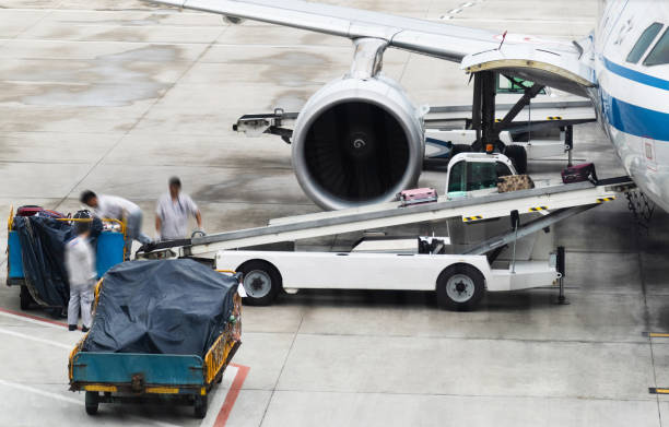 istock Loading luggage to airplane in airport 1133578966