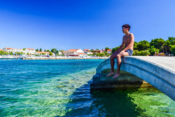 The guy on the bridge on the background of Vodice cityscape, Croatia.