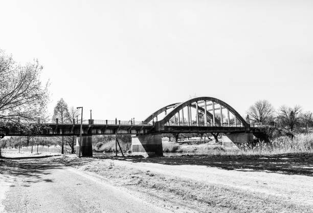 A street scene, with the Sarel Cilliers Bridge over the Vals River, in Kroonstad, a town in the Free State Province of South Africa. Monochrome