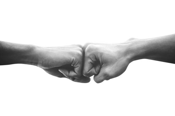 Hands of man people fist bump team teamwork and partnership business success, Black and white image Hands of man people fist bump team teamwork and partnership business success, Black and white image combat sport photos stock pictures, royalty-free photos & images
