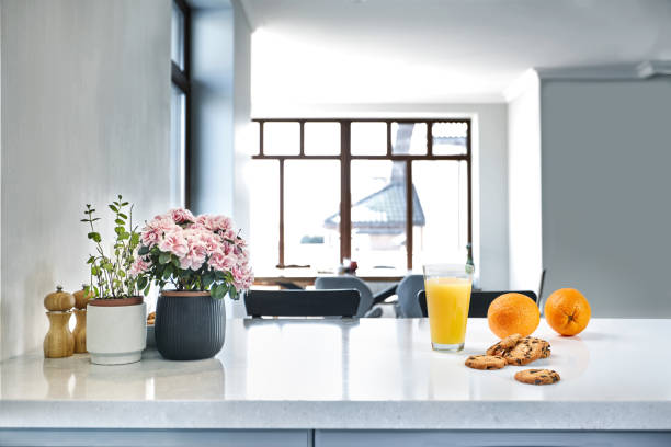 The beautiful vibrant red bouquet of tulips on the domestic kitchen in the morning light. Home decor and coziness