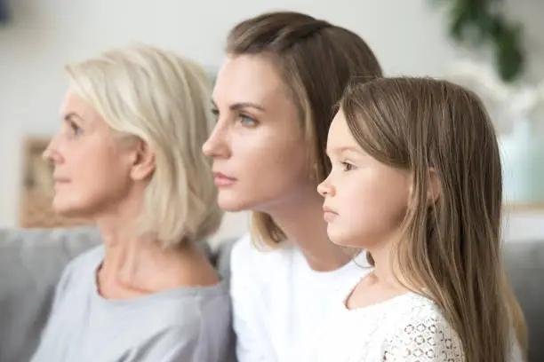 Profile family portrait, serious focused grandmother, mother and little daughter, thinking about future, aging process concept, three female different age generations, growing up