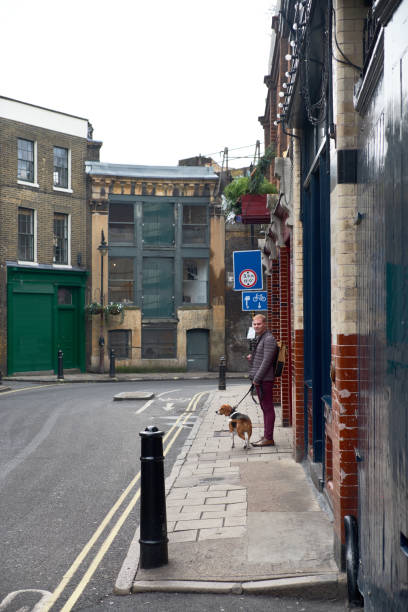 Photo of woman walking with a dog on a leash