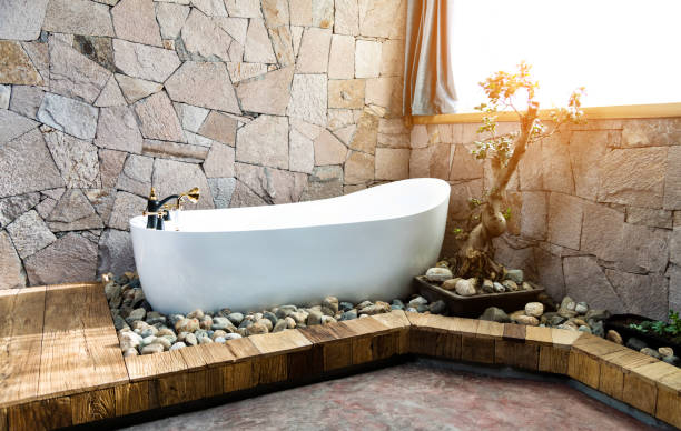 istock Modern bathroom with stone wall and bathtub 1133582624
