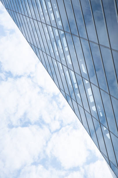 istock Cloud and sky reflected in the blue glass windows of building. 1133585101
