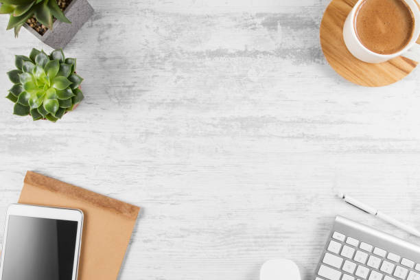 istock Directly Above View of Office Desk with Coffee Cup and Digital Tablet 1133585191
