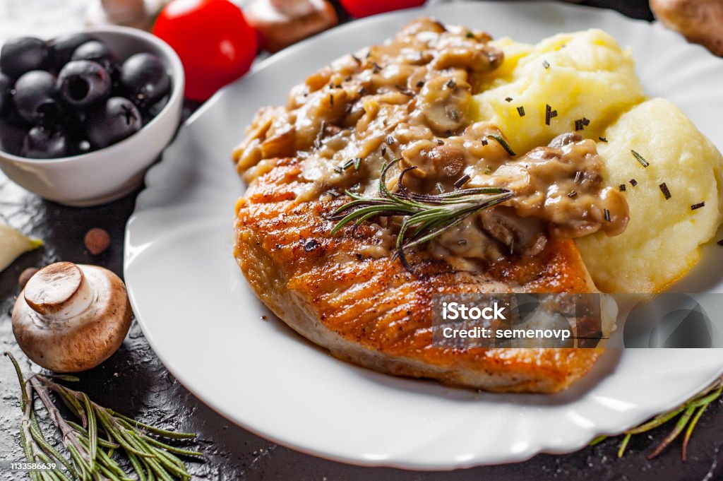 roasted Chicken Breast with Mushroom Sauce and mashed potato in white plate on dark background Chicken Meat Stock Photo