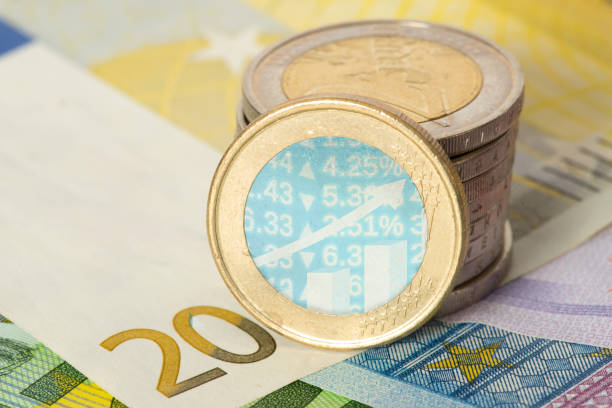 EUro notes and coins and a diagram with numbers EUro banknotes and coins and a chart with numbers büro stock pictures, royalty-free photos & images