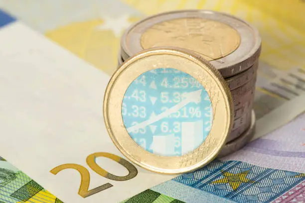 EUro banknotes and coins and a chart with numbers