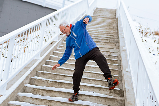 Senior man on a icy staircase
