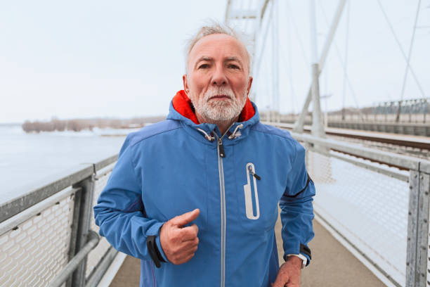 istock Senior man jogging on a city bridge 1133589116