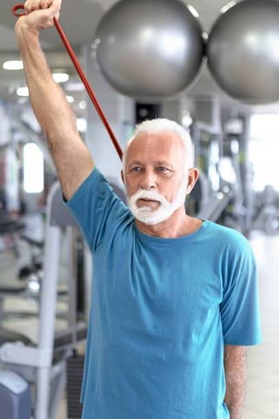 istock Senior man stretching resistance band 1133589717