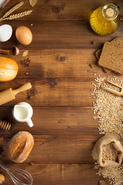 istock wheat grains and bakery ingredients on wooden background 1133589820