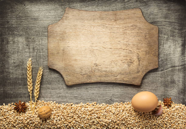 istock wheat grains and bakery ingredients on wooden background 1133589980