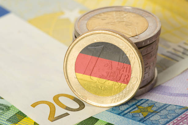 istock Euro notes and coins and flag of Germany 1133590101