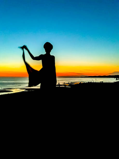 istock Woman Silhouette at Sunset Beach 1133590176