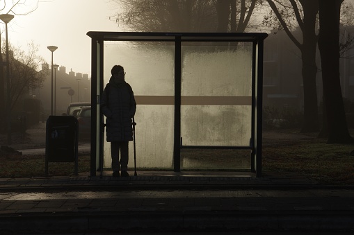 Brunssum, the Netherlands, - December 03, 20184. People waiting for the bus on a cold and misty winter morning.