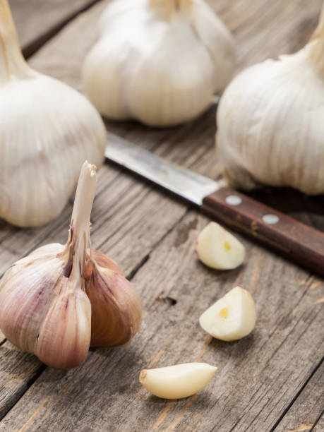 istock Whole and peeled garlic on a wooden table 1133591709