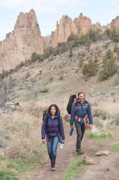 istock Two friends backpack along a dry wilderness trail together 1133591947
