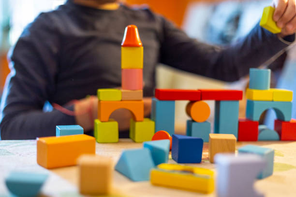 istock a child plays with colored wooden blocks at home. 1133591993