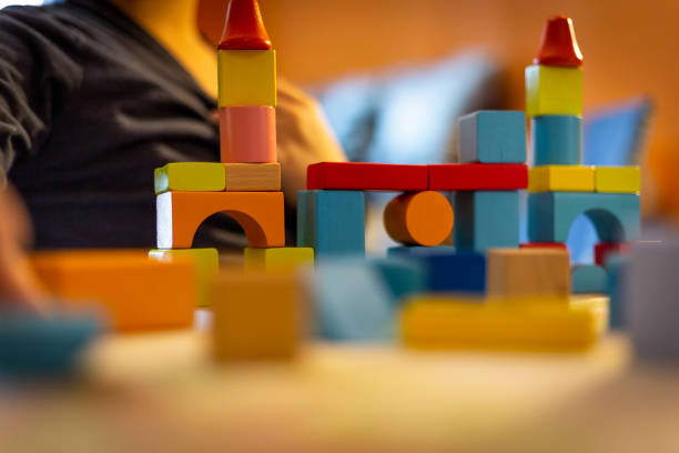 istock a child plays with colored wooden blocks at home. 1133592019