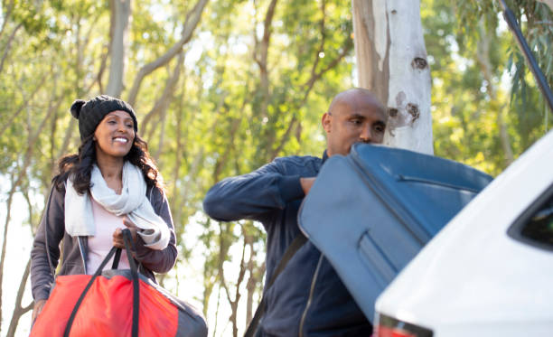 istock Couple loading luggage into car trunk for outdoors vacation. 1133592059
