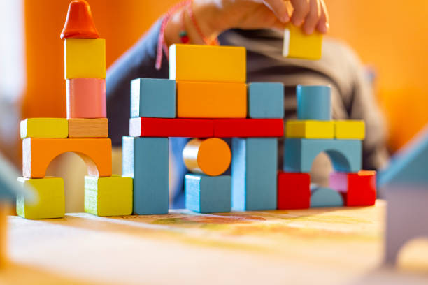 istock a child plays with colored wooden blocks at home. 1133592082