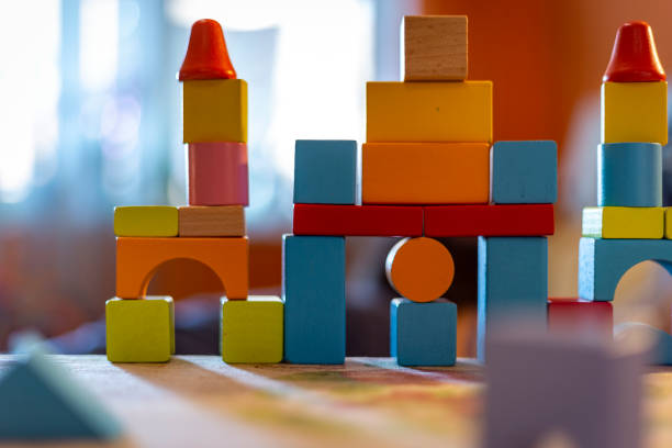 istock a child plays with colored wooden blocks at home. 1133592101