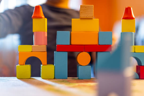 istock a child plays with colored wooden blocks at home. 1133592102