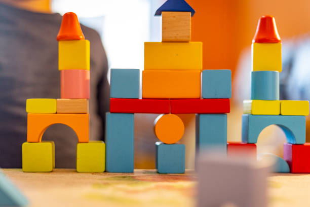 istock a child plays with colored wooden blocks at home. 1133592159