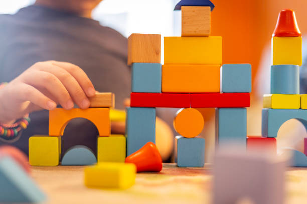 istock a child plays with colored wooden blocks at home. 1133592221