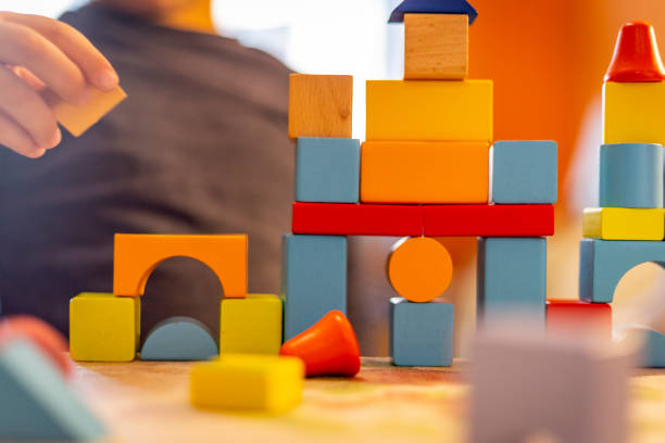 istock a child plays with colored wooden blocks at home. 1133592228