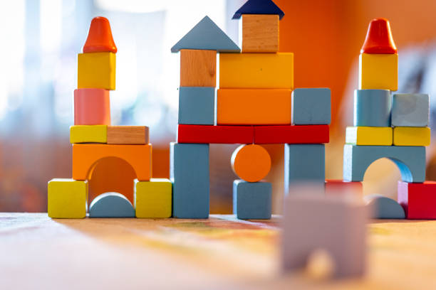istock a child plays with colored wooden blocks at home. 1133592229