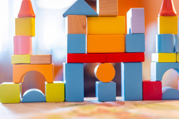 istock a child plays with colored wooden blocks at home. 1133592308