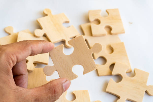istock Hand team put missing jigsaw puzzle on the air 1133593648