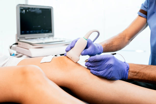 Physiotherapist giving knee therapy to a woman Physiotherapist giving knee therapy to a woman in clinic. Physical treatment concept ultrasound photos stock pictures, royalty-free photos & images