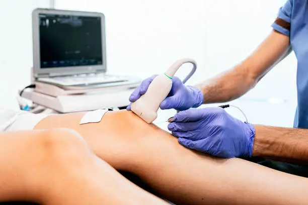 Photo of Physiotherapist giving knee therapy to a woman