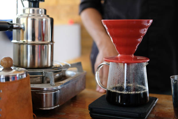 istock hot water pouring on coffee power in filter paper 1133594199