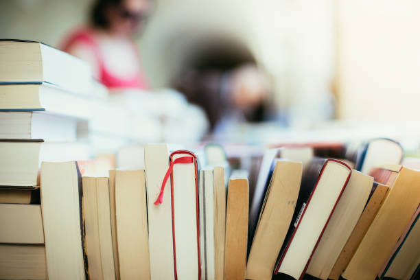 Stack of books at a charity book flea market, text space