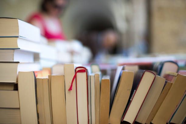 istock Stack of books at a charity book flea market, text space 1133594216