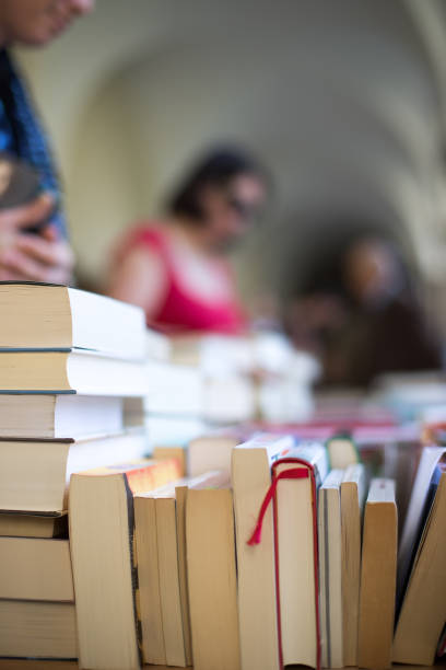 istock Stack of books at a charity book flea market, text space 1133594234
