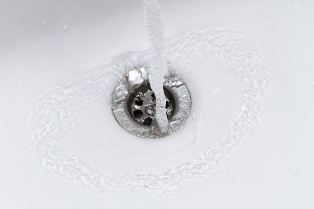 istock water falling in slow motion into sink, drain closeup 1133594270
