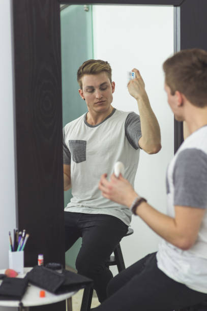 istock Man gets dressed in drag attire in bathroom 1133594472