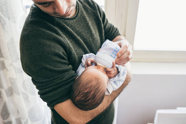 istock Dad feeding newborn baby boy 1133595422