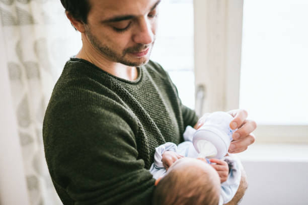 istock Dad feeding newborn baby boy 1133595451