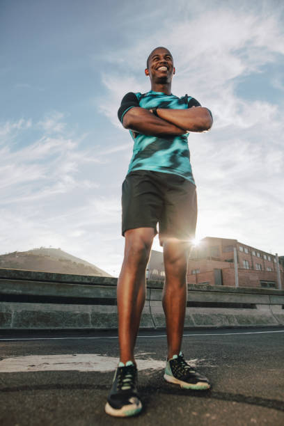 istock Smiling runner standing on the street in morning 1133595476