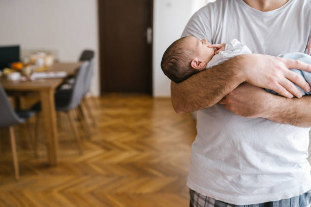 istock Unrecognizable father holding little baby 1133595702